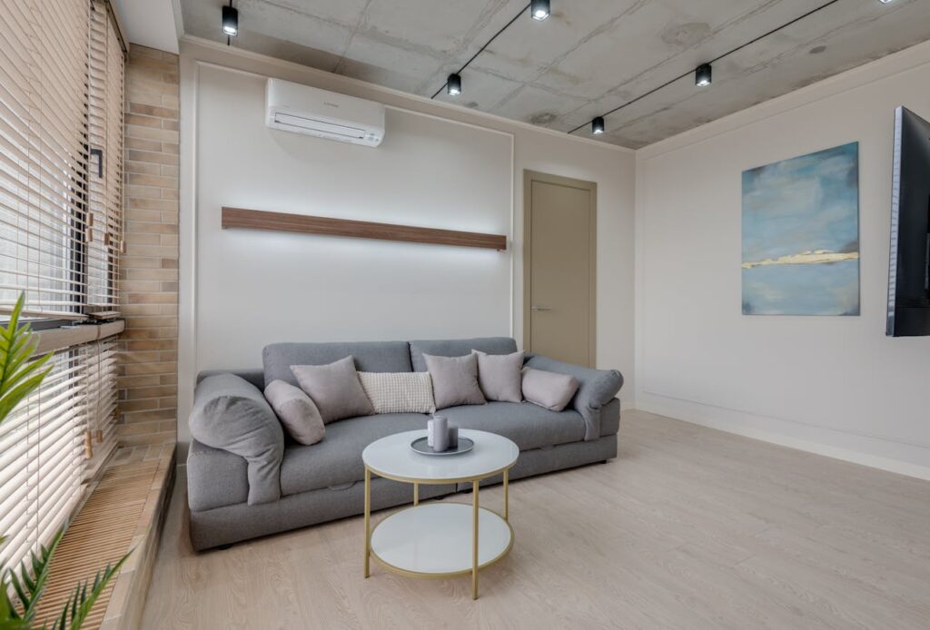 Stylish living room with a gray sofa, abstract art, and minimalist design.